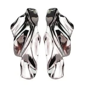Two abstract, silver-colored earrings with a flowing, organic design