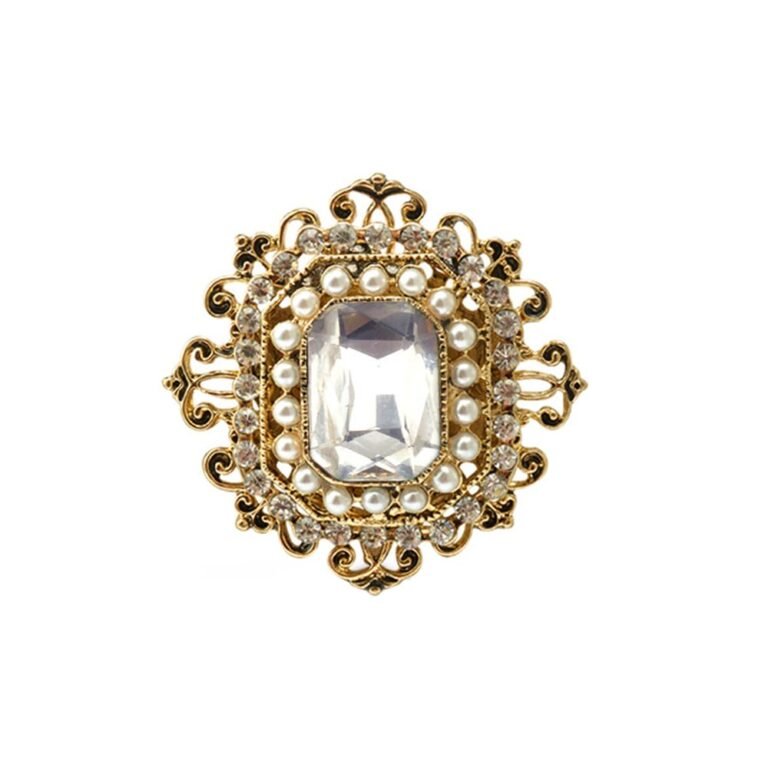 Gold brooch with a large clear gem, pearls, and small crystals