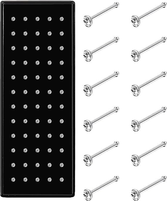 A black tray of nose studs with several individual nose studs