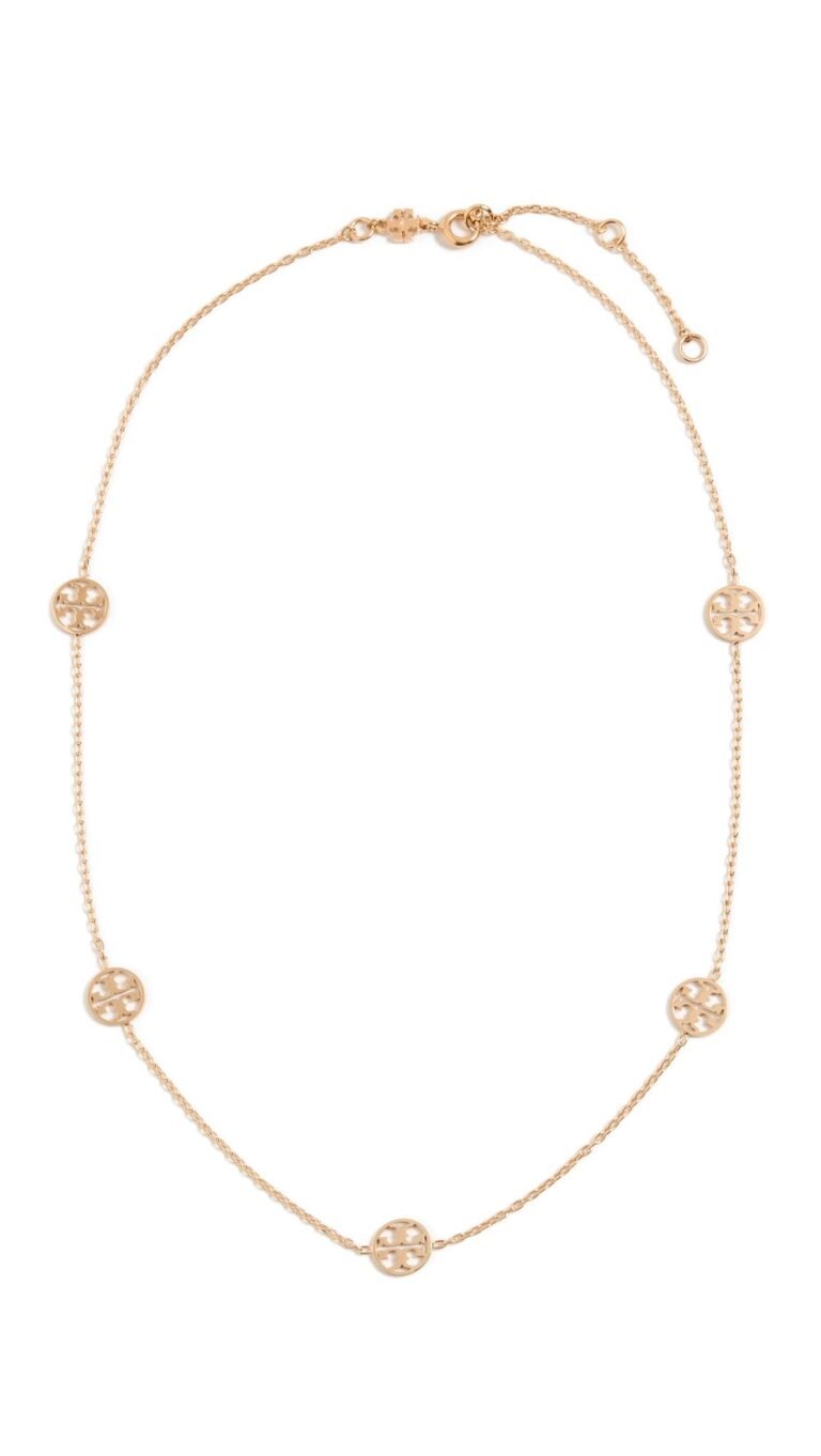 Gold necklace with multiple circular logo charms, on a white background