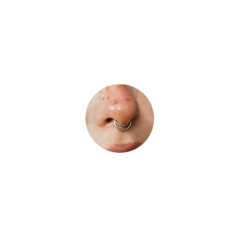 Close-up of a nose with a septum piercing, silver double hoop