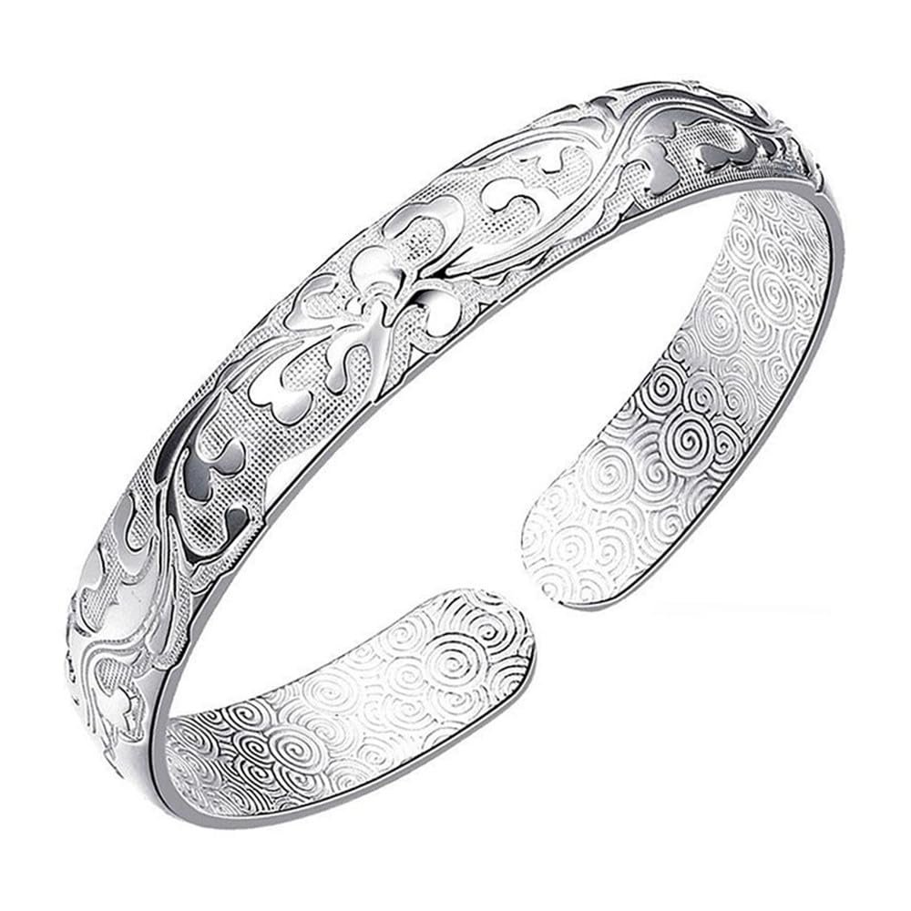 Silver open cuff bracelet with floral and swirl pattern details