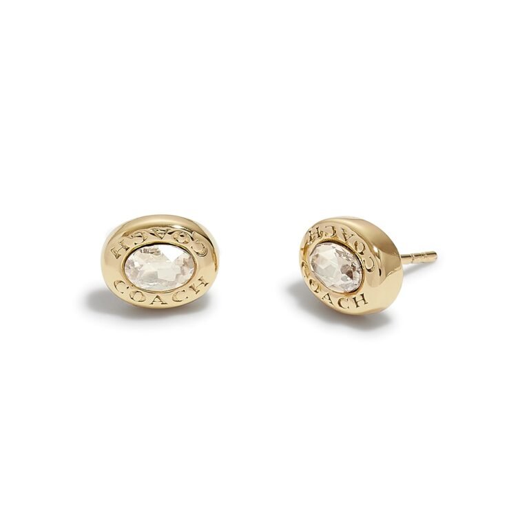 Gold Coach stud earrings with oval crystal center and logo