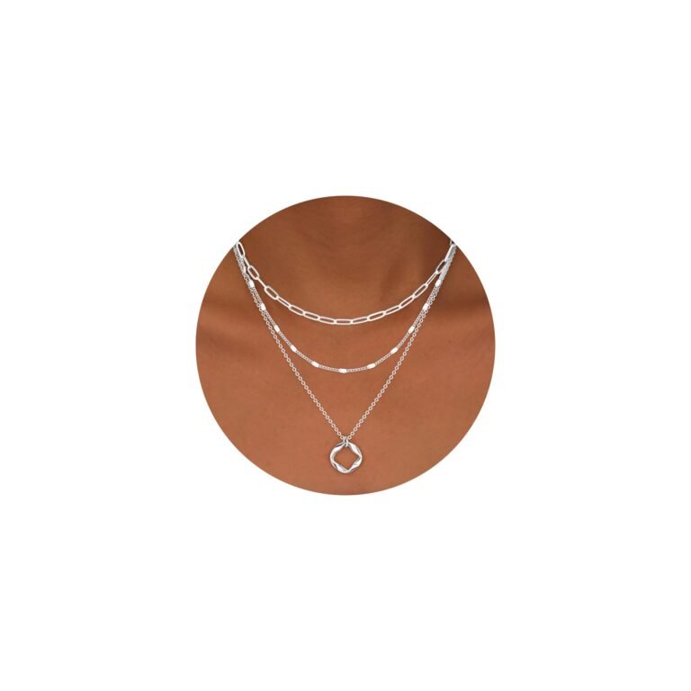 Three layered silver necklaces on a person's neck, with a pendant