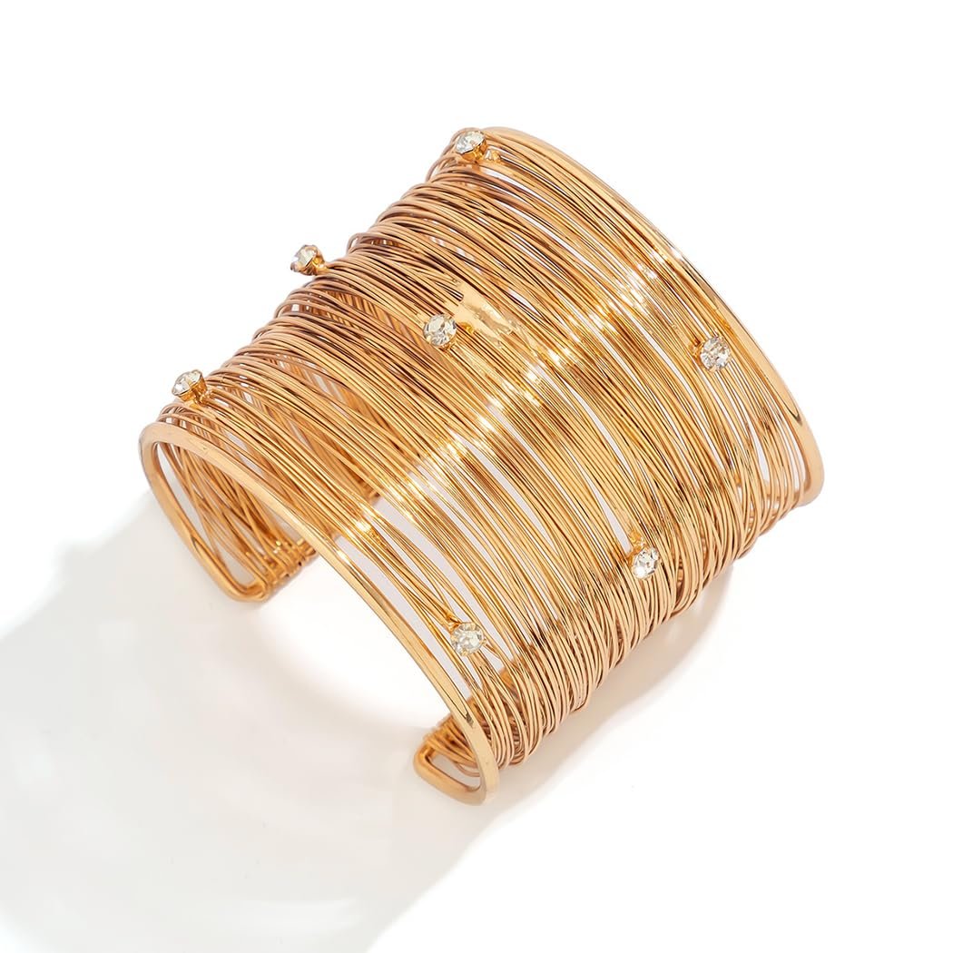 Gold wire cuff bracelet with small diamond accents on white background