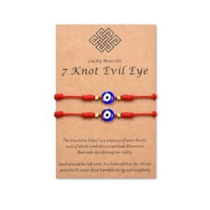 Two red string bracelets with blue evil eye beads on a card