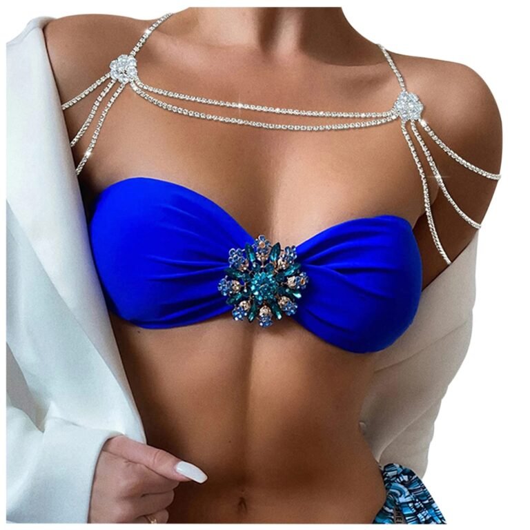 Woman wearing a blue bikini top with jeweled embellishments and a shoulder necklace