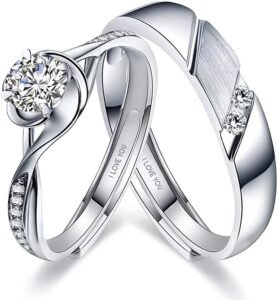 Two silver wedding rings with diamonds and "I Love You" inscription