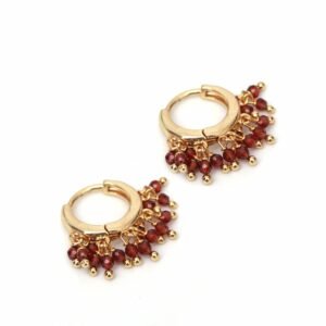 Gold hoop earrings with dangling red beads and gold accents