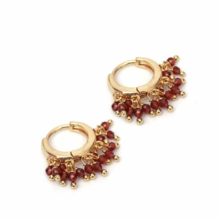 Gold hoop earrings with dangling red beads and gold accents