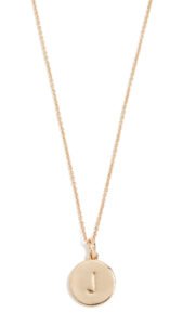 Gold necklace with a circular pendant featuring the letter "J"