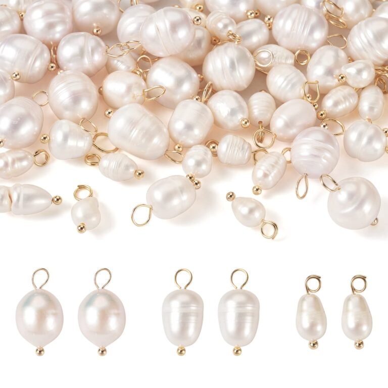 White pearl pendants with gold loops and gold beads, arranged on white