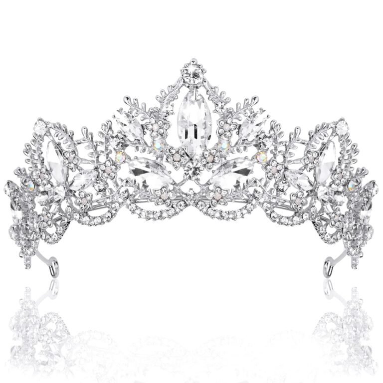 Silver tiara with clear crystals and floral details, reflecting on white surface
