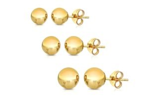 Three pairs of gold ball stud earrings on a white background